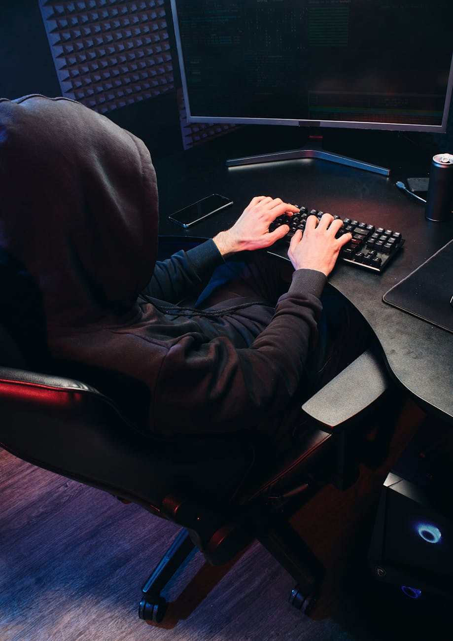 back view of a person typing on a keyboard